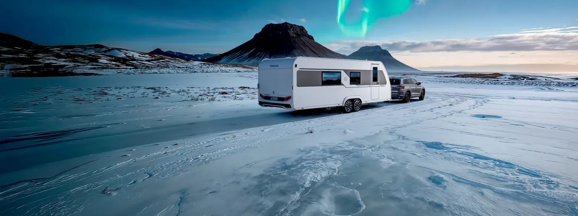 Knaus Nordwind campingvogn blir dratt av en Skoda på en snødekt veg